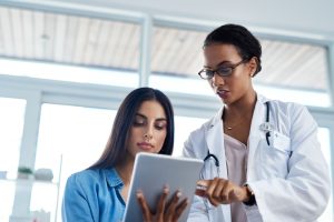 Doctor,,Talking,And,Woman,On,Tablet,With,Patient,To,Show