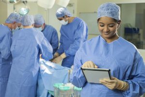 Young,Female,Woman,Nurse,Doctor,Surgeon,Using,Tablet,Computer,With