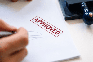 approved-stamp-man-signing