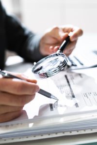 Businessman,Finance,Investigation,Using,Magnifying,Glass.,Fraud,And,Audit