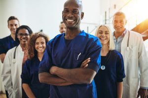 Young,African,Male,Doctor,Smiling,While,Standing,In,A,Hospital