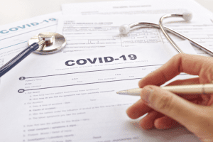 covid-paperwork-stethoscope-hand-pen