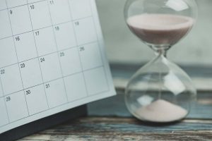 Calendar,And,Hourglass,On,Wood,Table,,Vintage,Style.