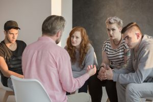 Addiction,Counselor,Talking,To,Group,Of,His,Teenage,Patients