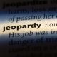 The word "Jeopardy" in a blurred page in a book