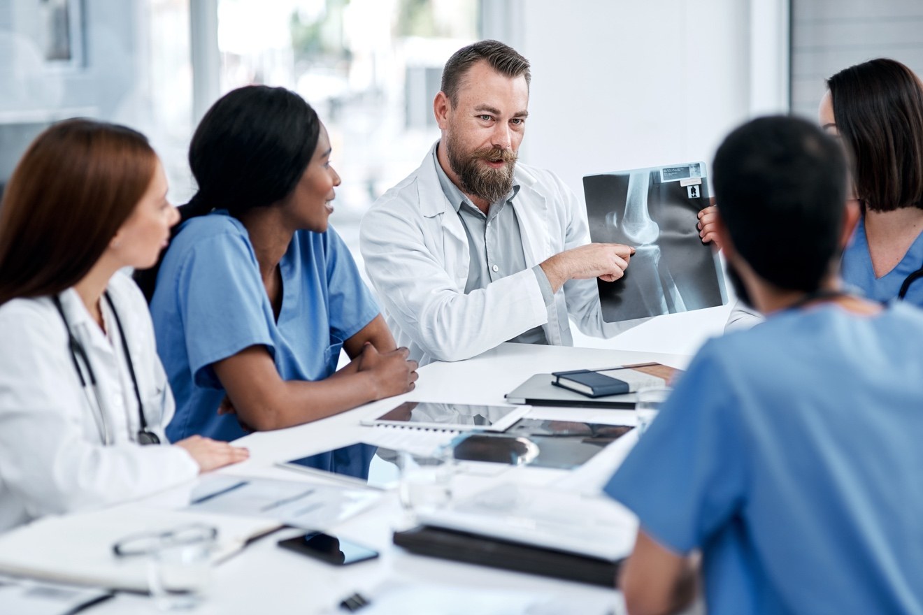 Healthcare leaders reviewing care delivery and joint replacement outcomes