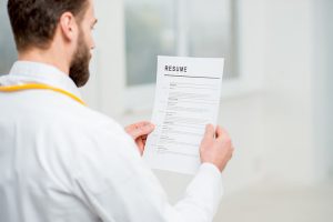 Doctor reading resume for job hiring in the hospital