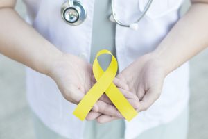 Professional,Doctor,In,White,Uniform,Yellow,Ribbon,Awareness,In,Hand