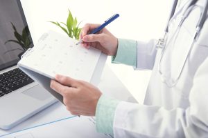 doctor making a note on a calendar
