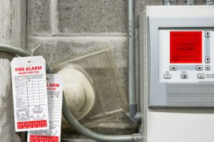 Fire alarm inspection tags with fire alarm panel.