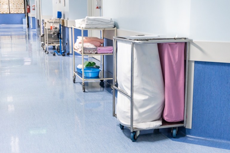 Hospital laundry and linen carts in a corridor
