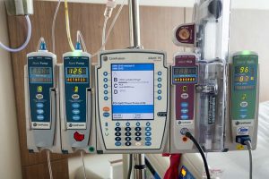 patient monitoring and Intravenous equipment in a modern hospital room. This equipment monitors and regulates a variety of medication