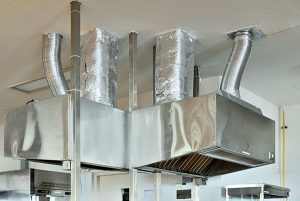 Big steel stainless cooker hood in industrial kitchen
