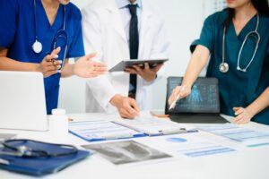 Nurses and a dr looking at paperwork