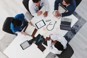 overhead shot of drs meeting at a conference table