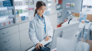 pharmacist in pharmacy checking medications