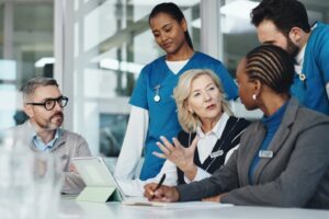 medical professionals looking at information on ipad together