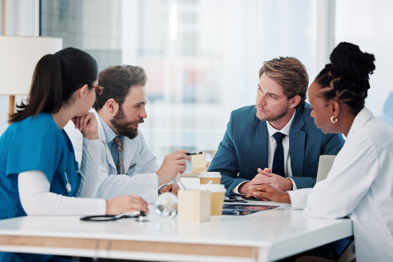 Healthcare professionals meeting at a conference table