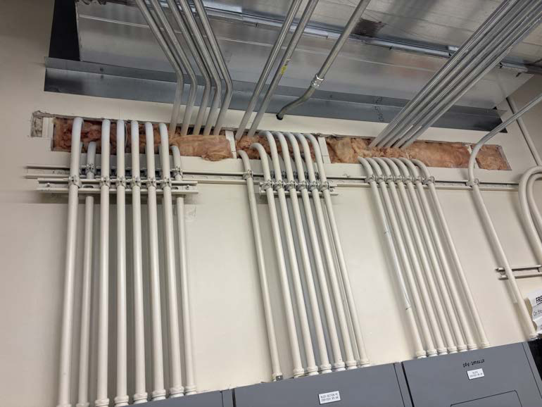 Pipes and cables penetrating a wall barrier